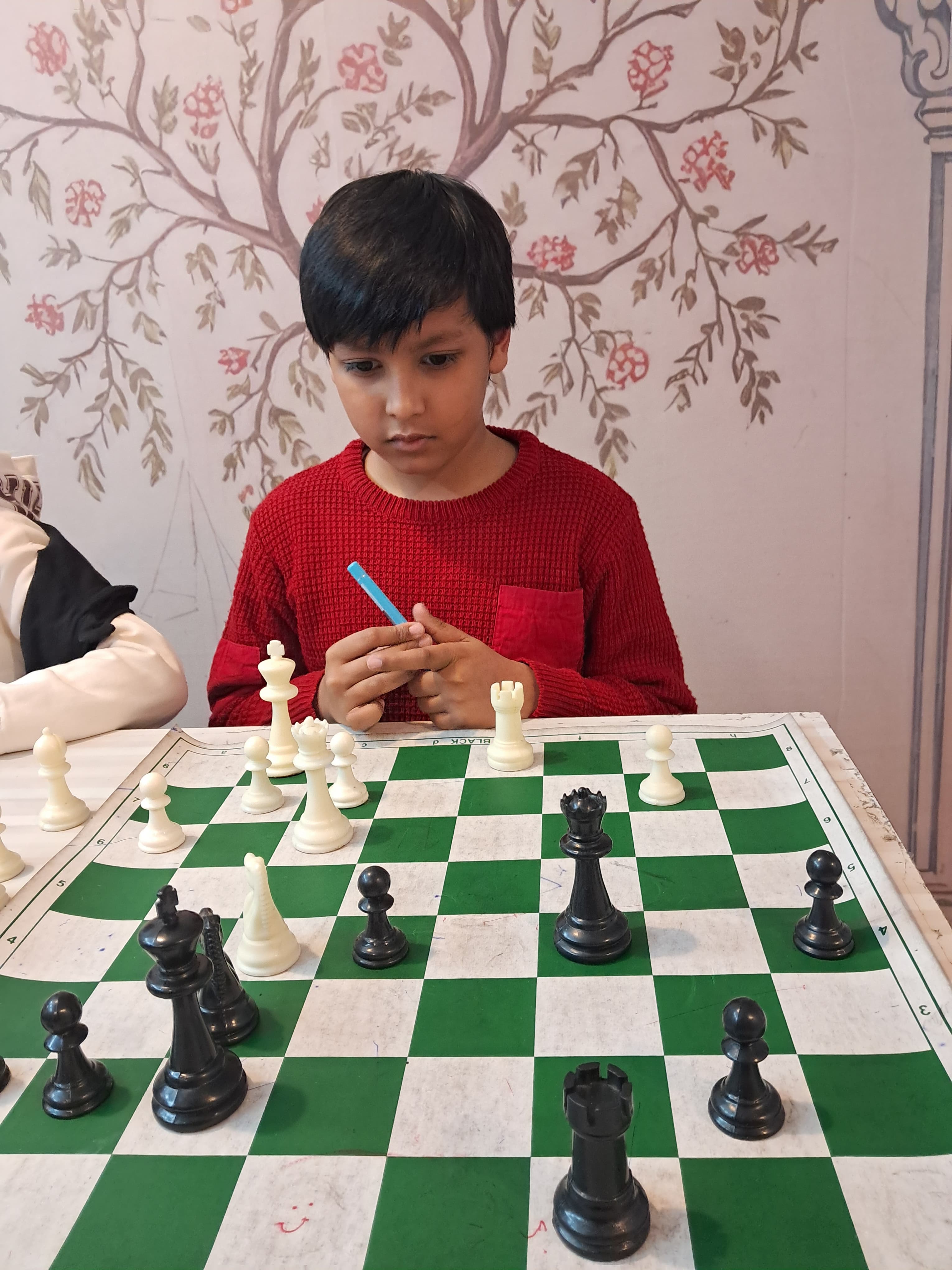 Young chess player seated confidently before match begins