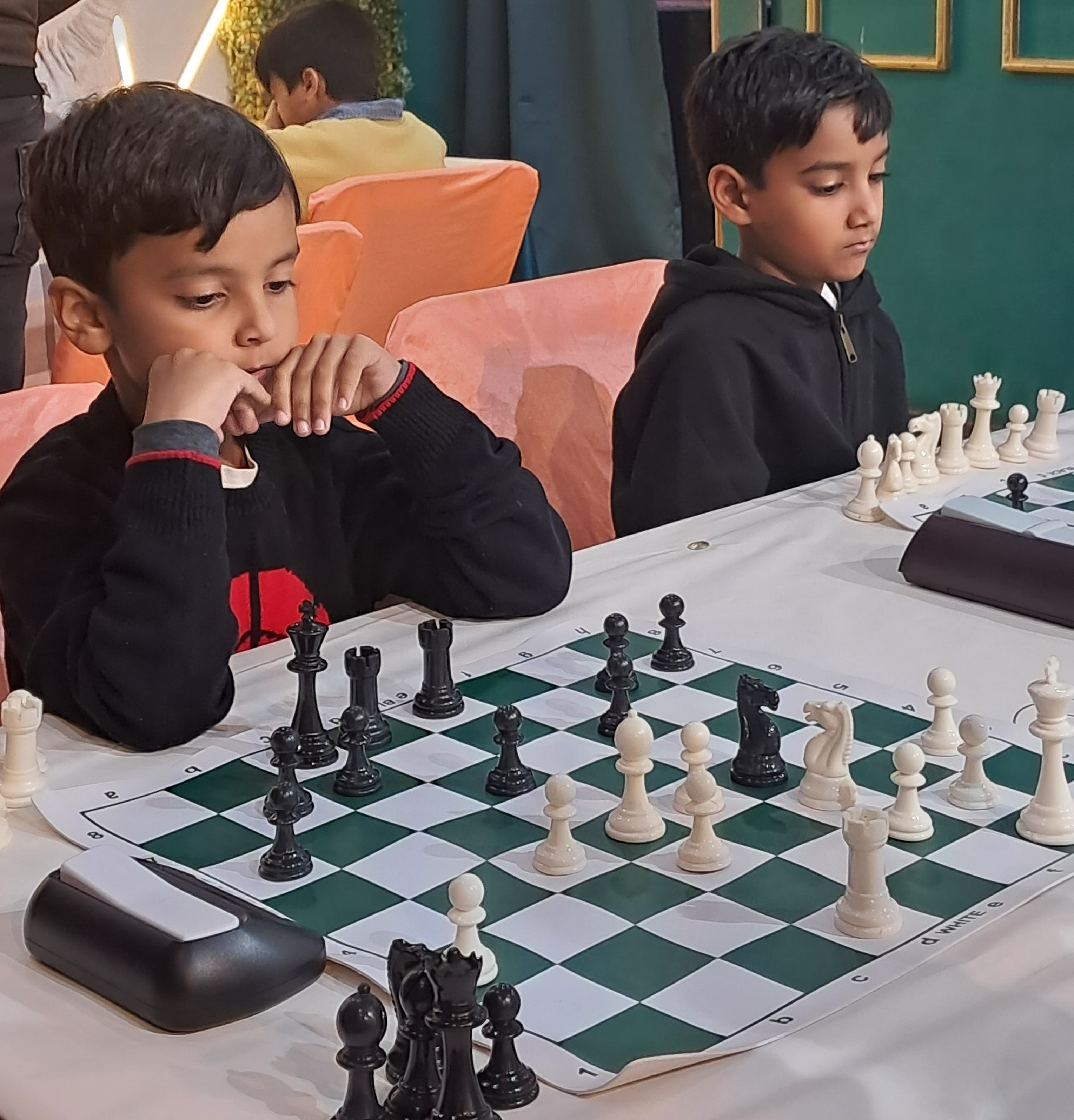 Confident young chess player smiling during tournament