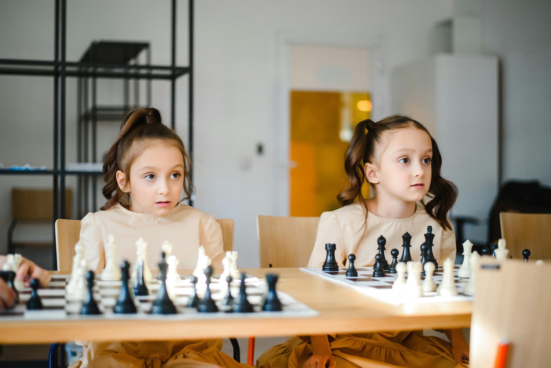Children learning chess in a structured academy environment