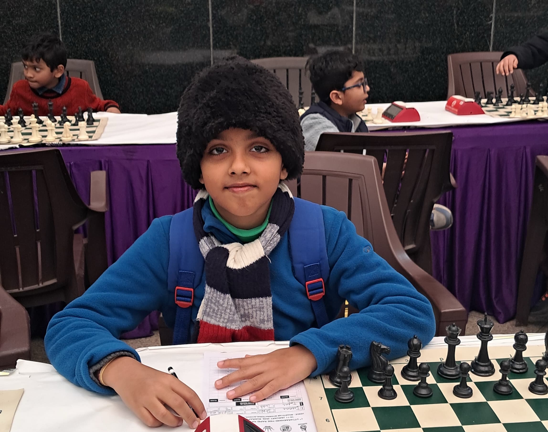 Children participating in structured chess lesson