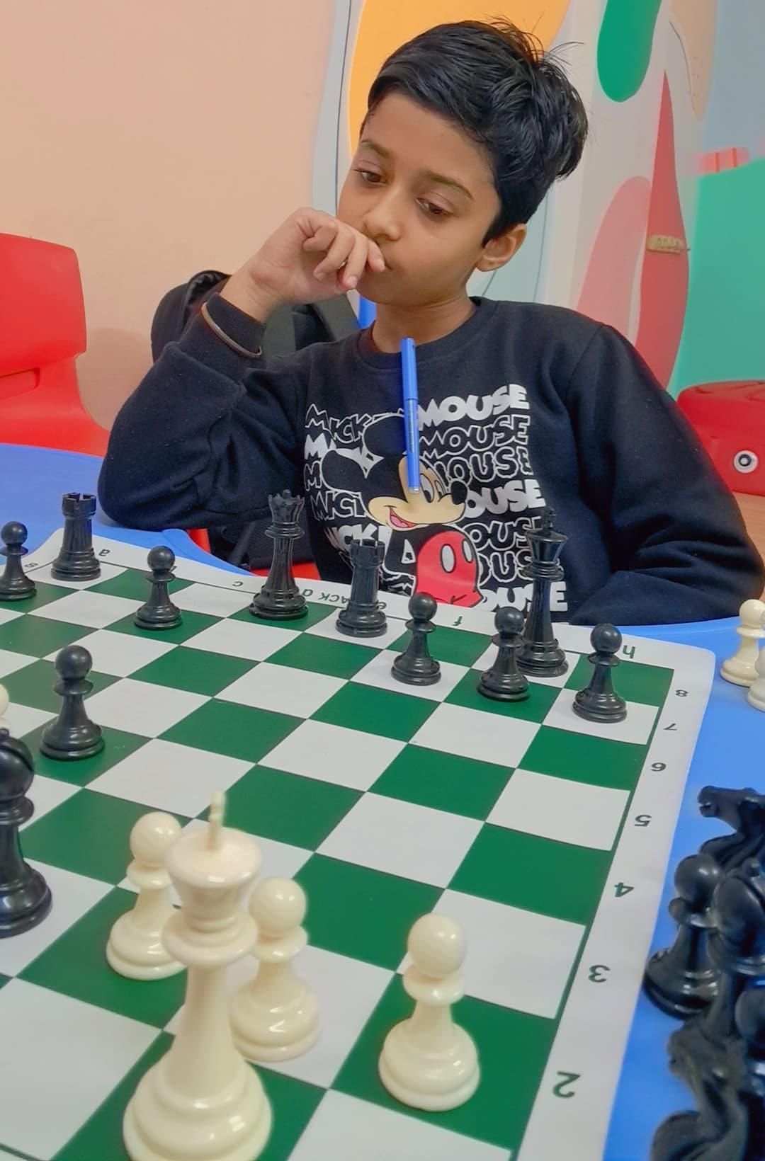 Wide view of students competing in organized chess tournament hall