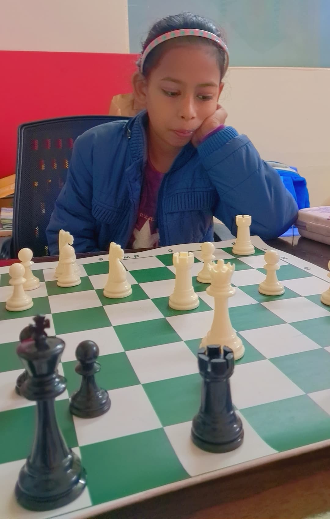 Group of children practicing chess strategies in classroom