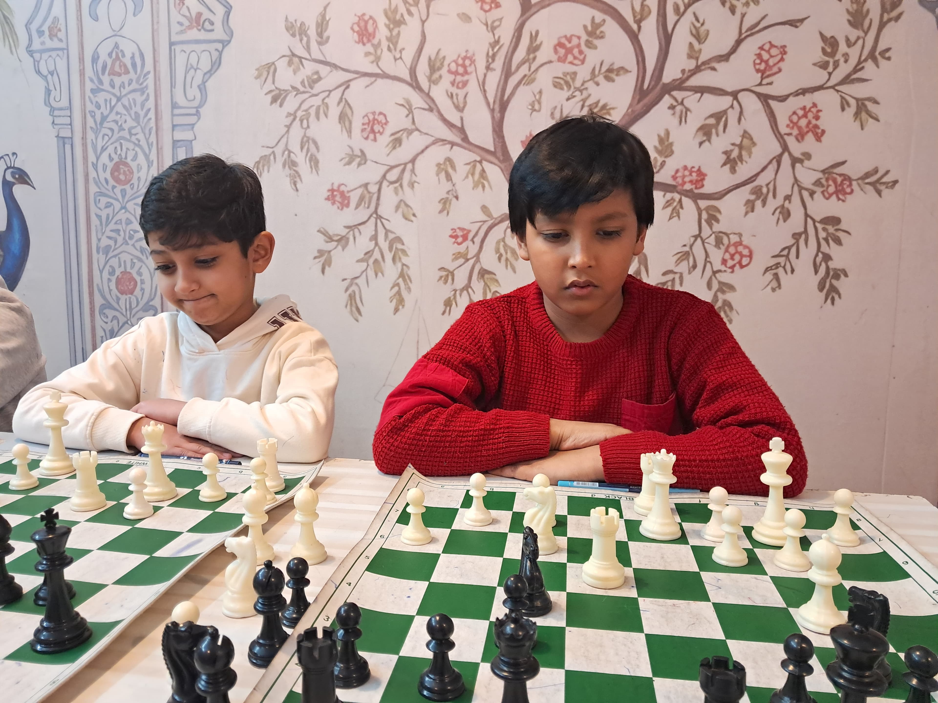 Young students playing timed chess match in classroom setting