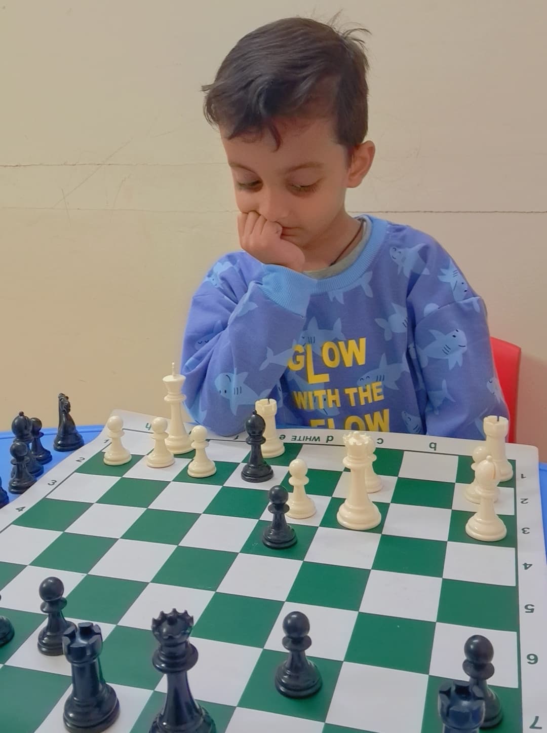 Group chess practice session inside academy classroom